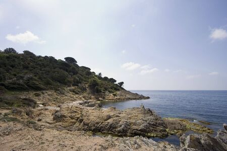 narrow path between the cliffs on the mediterranean sea - gulf of saint-tropez, french rivieraの写真素材