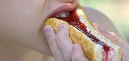 teenager eating baguette 