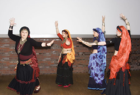 women belly dancing - performance in a traditional outfit