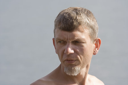 Mature man portrait - in front of a gray background