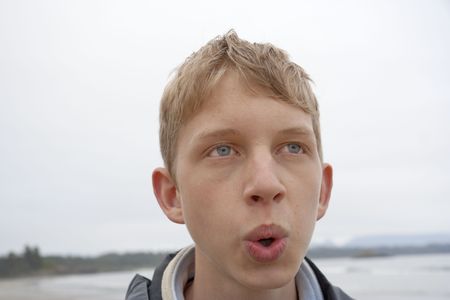 Portrait of whistling Teenage boy - Long Beach, Pacific Rim National Park, Vancouver Island, British Columbia, Canadaの写真素材