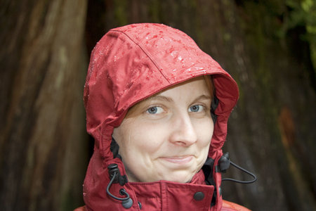 Young Woman with Hood in the Rain - Portrait in Rainforest, Vancouver Island, British Columbia,...