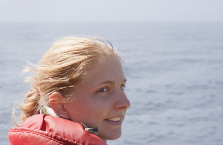 Young Woman with red Floatation Suit - Portrait on a Whale Watching Tourの写真素材