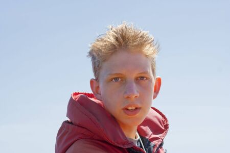 Teenage Boy with red Floatation Suit - Portrait on Whale Watching Tourの写真素材