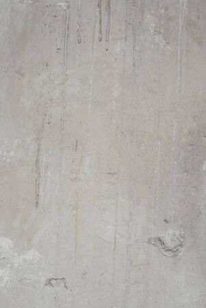 generic background of a marbled concrete wall or floor surface stained of age and usage over a long period of time in light beige colorsの写真素材