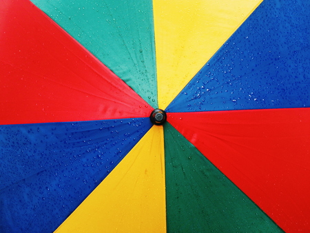 Water drops on Rainbow umbrellaの写真素材