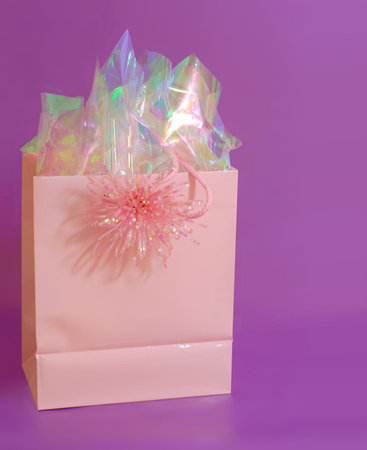 Pink gift bag on purple backgroundの写真素材