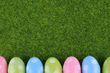 Cute Easter image with green grass as a background and sparkly colored eggs as a lower border. Copy...