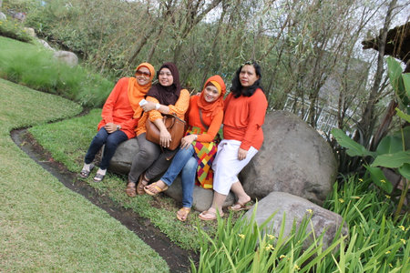 Lembang, Indonesia - Jan 22, 2023 : group of asian women sitting on the grass in the garden.のeditorial素材