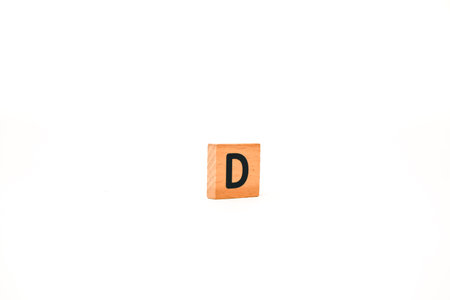 Letter D on a wooden block, isolated on a white background, educational concept
