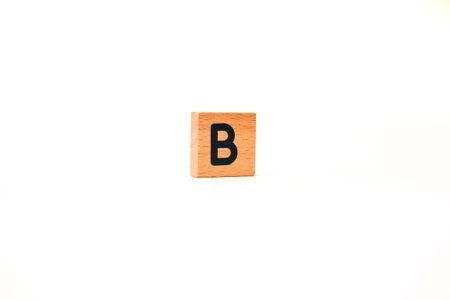 A single wooden block with the letter B in black, isolated on a white background perfect for...