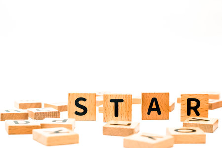 Wooden blocks spelling the word star against a white background educational conceptの写真素材