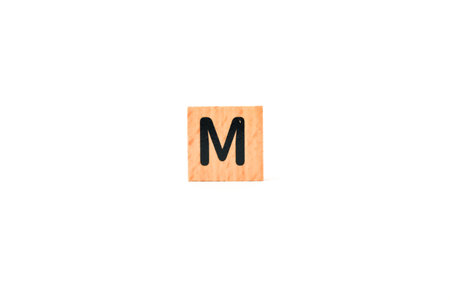 Wooden tile with the letter M in black, isolated on white background
