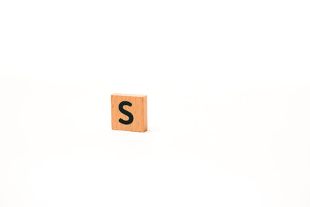 Wooden alphabet block featuring the letter 'S', isolated against a clean white background