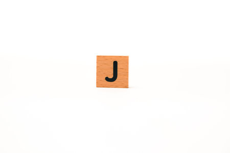 Wooden block with letter J, perfect for educational materials or design elementの写真素材