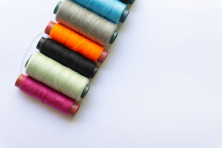 Top view of colorful yarn on white background with various layouts.