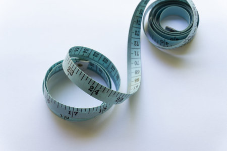 Blue measuring tape with various layouts isolated on white background.