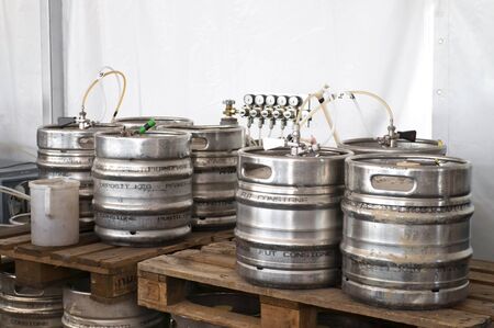 Steel indutrial barrels of beer stocked in storageの写真素材