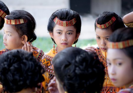 Children dressed with traditional toraja clothes during a funeral ritual in Indonesian village on 15th August 2010のeditorial素材