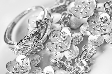 White gold jewelry ring and bracelet in white background