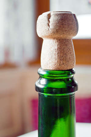 Opened champagne plug over a green bottleの写真素材