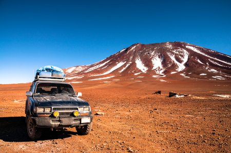 4x4 offroad vehicle in the middle of peruvian highlands with mountain in background