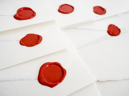 group of white letters closed by red sealing waxの写真素材