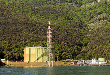Gas and oil deposit in sea shore, with green environmentの写真素材