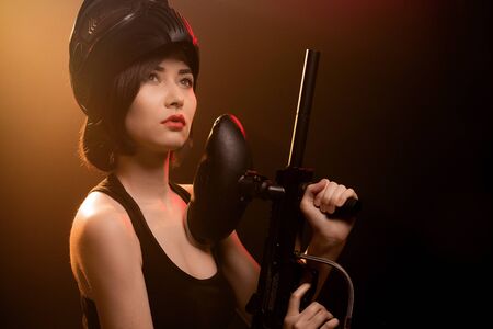 Girl aiming to shoot asian girl paintballの写真素材