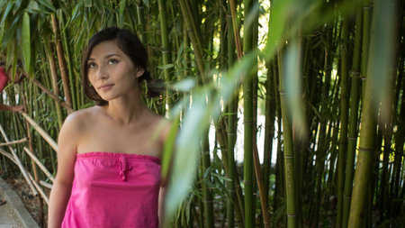 dreamy girl with pink fresh flowers outdoor, seasonal nature, tree branch and glamorous lady.の写真素材