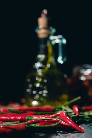 olive oil, baked tomatoes and chilli on black backgroundの写真素材