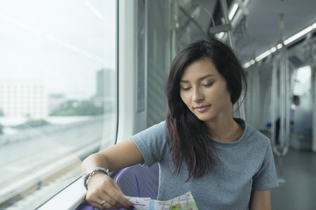 young girl in sky train in Thailandの写真素材