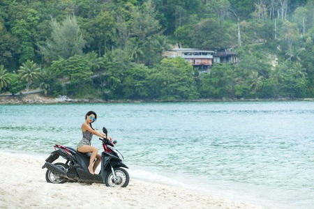 Pretty woman on her scooterの写真素材