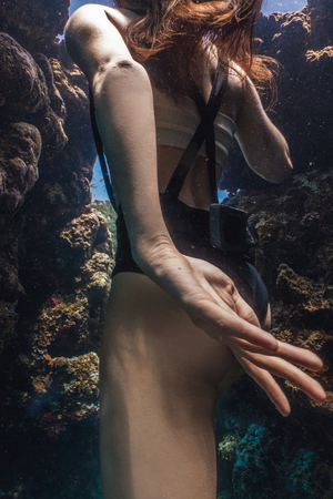 Young asian woman closeup freediving in cavesの写真素材