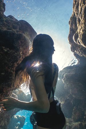 Mysterious frame of an asian woman freedivingの写真素材