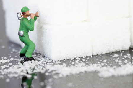 miniature scale model builders breaking up sugar cubes.の写真素材