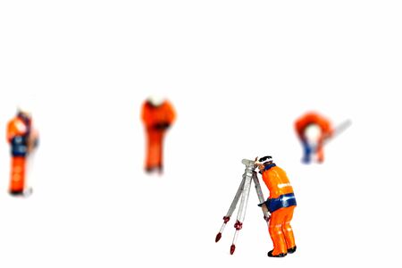 Miniature scale model construction workers isolated on white backgroundの写真素材