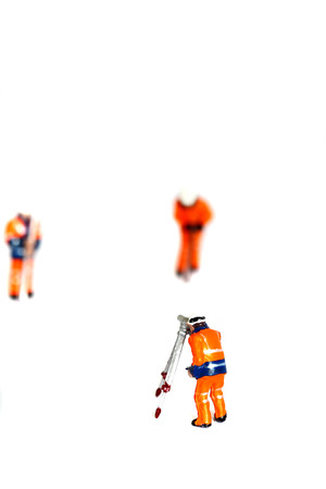 Miniature scale model construction workers isolated on white backgroundの写真素材
