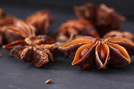 Star Anise on a black wood backgroundの写真素材
