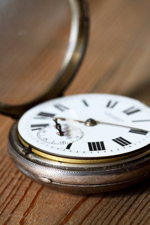 Antique pocket fob watch on a wooden backgroundの写真素材