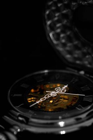 Antique pocket fob watch on black backgroundの写真素材