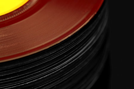 Abstract image of a stack of old vinyl records with selective color