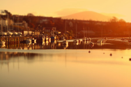 Caernarfon Harbour in Wales,  United Kingdom,  at sunrise.  Edited using tilt and shiftの写真素材
