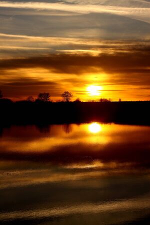 Flood in a field at sunsetの写真素材