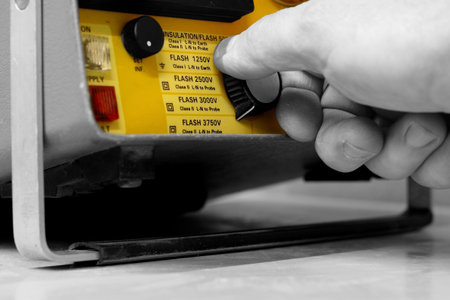 Abstract selective color image of a man using electrical test equipment