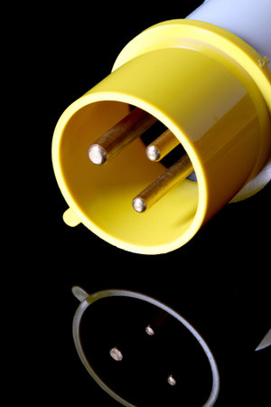 An industrial electric plug on black background.