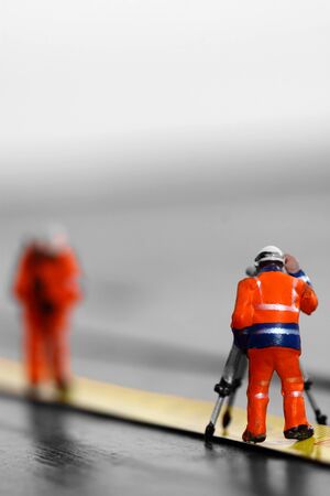 Scale model construction workers on a tape measure with selective colourの写真素材