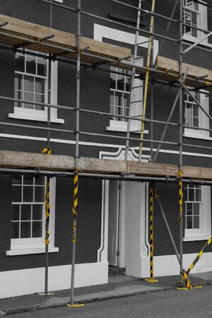 Scaffolding on the front of a house.  Edited with selective colourの写真素材