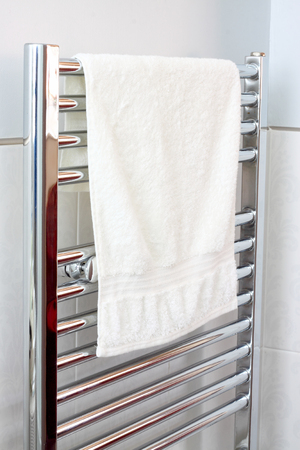 Towel on a modern bathroom chrome radiatorの写真素材