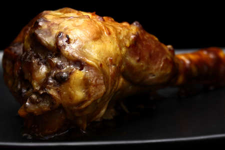 Lamb shank on a black plate and backgroundの写真素材